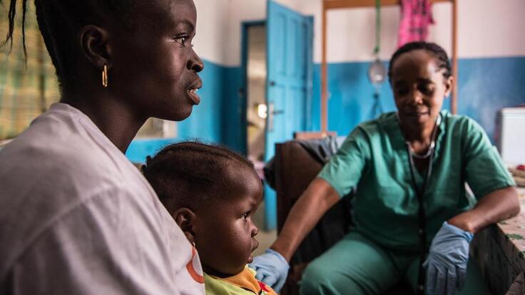 A mother and child visiting a health clinic.