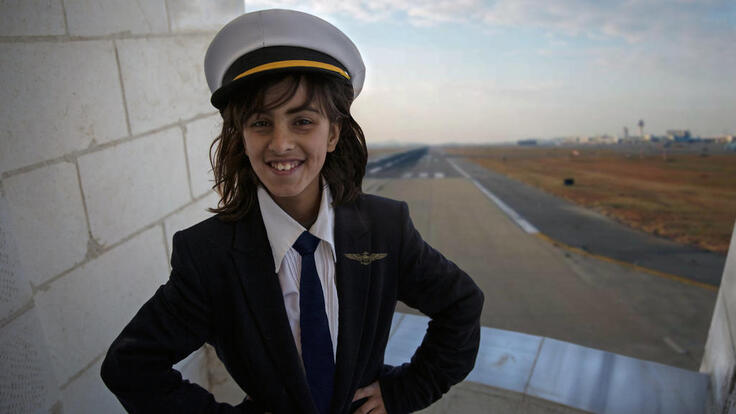 A girl wearing a sailor's costume.