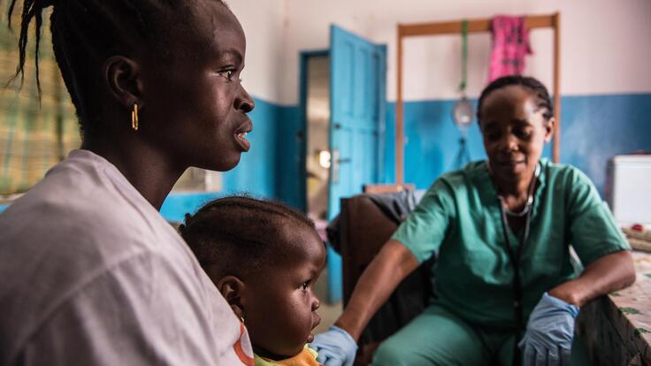 A mother and child visiting a health clinic.