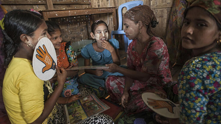 A group of women and girls partaking in women’s protection and empowerment activities.