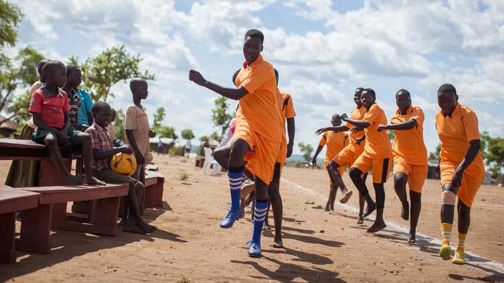 A soccer team dancing.