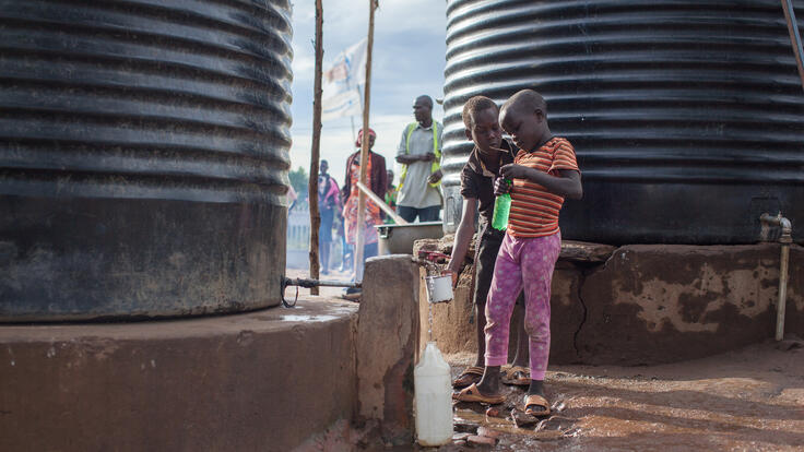 A group of children drinking water.