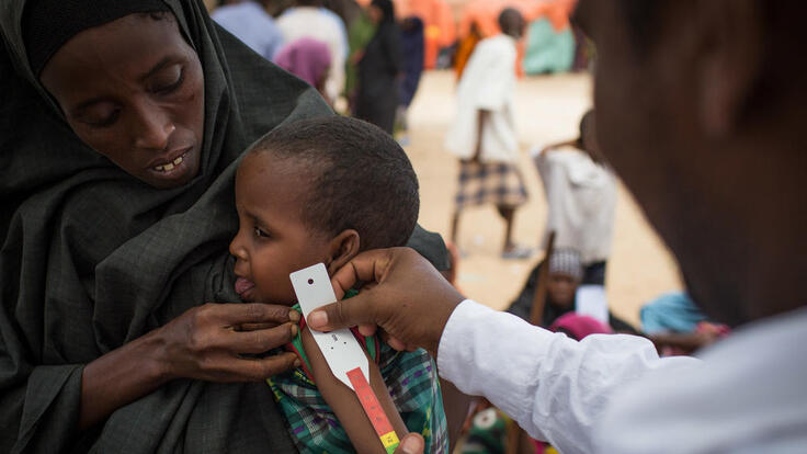 Small child being treated at a mobile medical clinic.