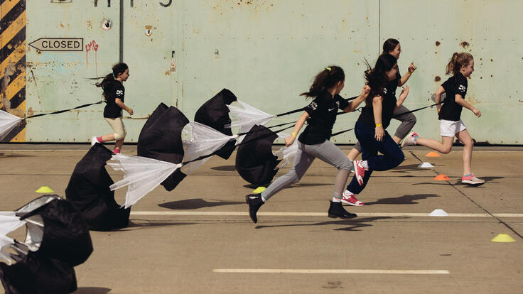 Children running a parachute race.