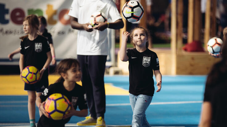 Children playing football.