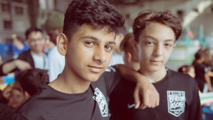 Two boys posing for a photo.