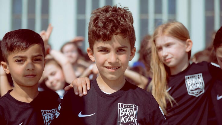 A group of kids wearing Nike shirts.