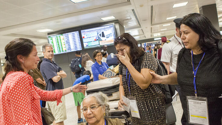 Two families meeting at the airport.