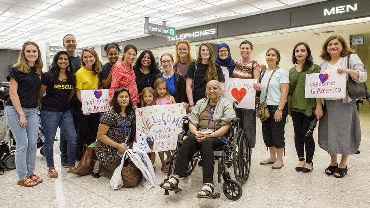 The IRC staff, volunteers and members welcoming the Sadiq family.