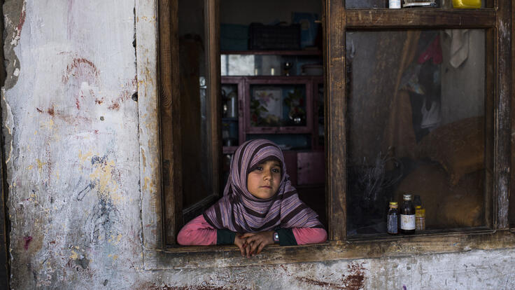 A girl looking out of a window.