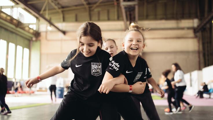 Three girls playing soccer.