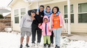 The five Ngalamulume siblings pose for a picture in the snow in their family's front yard in Boise.