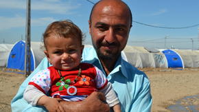 Displaced Iraqi father with his baby daughter
