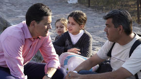 IRC president David Miliband speaks with refugees in Greece