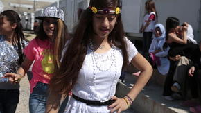 Nazia and Rolian dance outside at Elonas refugee camp. 
