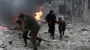 Syrian civilians run for cover from bombardment in Eastern Ghouta, Syria. Photo: Abdulmonam Eassa/AFP