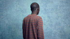 John photographed facing away from the camera