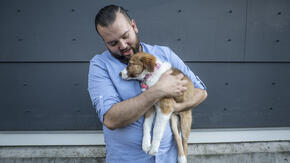 Suamhirs Piraino-Guzman with his dog, Lilly, outside his home in Seattle