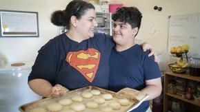 10-year-old Yousif holds a plate of shakar lama cookies with his mom, Taghreed