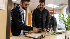 IRC caseworker Qais Nayab and Iranian refugees Sirvan and Saltanat Moradi at IRC offices located in SeaTac, WA