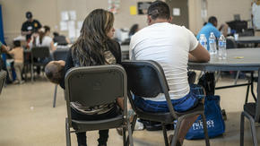 Central American family with a baby at an IRC day center in Phoenix, Ariz.