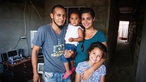 Andrea Rodriguez with her husband and two daughters in their home in Venezuela.