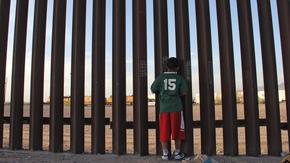 A Mexican child looks at a vehicle of the US border patrol through the US-Mexico fence in Ciudad Juarez, Chihuahua state, Mexico on April 4, 2018. Photo: HERIKA MARTINEZ/AFP/Getty Images 