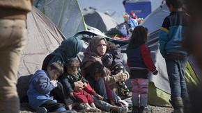 A refugee family find temporary shelter in a camp in Greece. Photo taken by Jodi Hilton for the IRC.