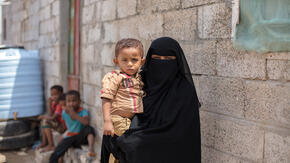 A Yemeni mother holds her young son.