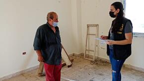 Assad speks with an IRC assessment team member in his Beirut home