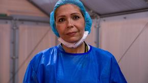 Dr. Edna Gomez, wearing protective gear, in a COVID-19 triage tent at the Colombia-Venezuela border.