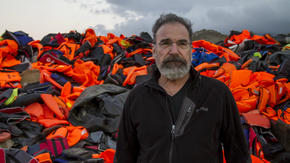 Mandy Patinkin with lifejackets used by refugees