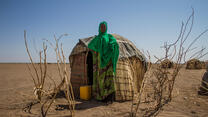 Sada Mohammed, 30, stands in front of her temporary shelter near a remote village in the Somali region of Ethiopia, which is experiencing the country's worst drought in 50 years. Woman stands in front of temporary shelter in drought-afflicted region.