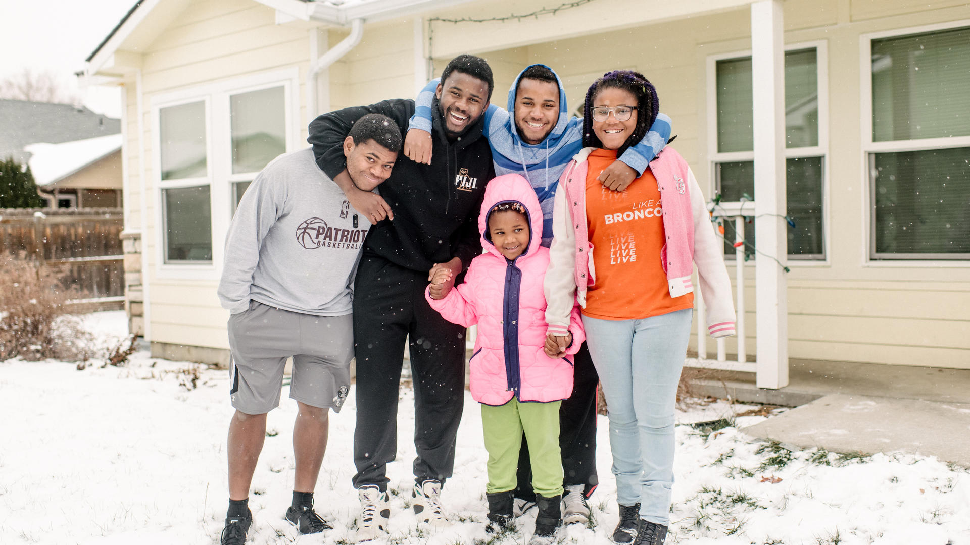 The five Ngalamulume siblings pose for a picture in the snow in their family's front yard in Boise.