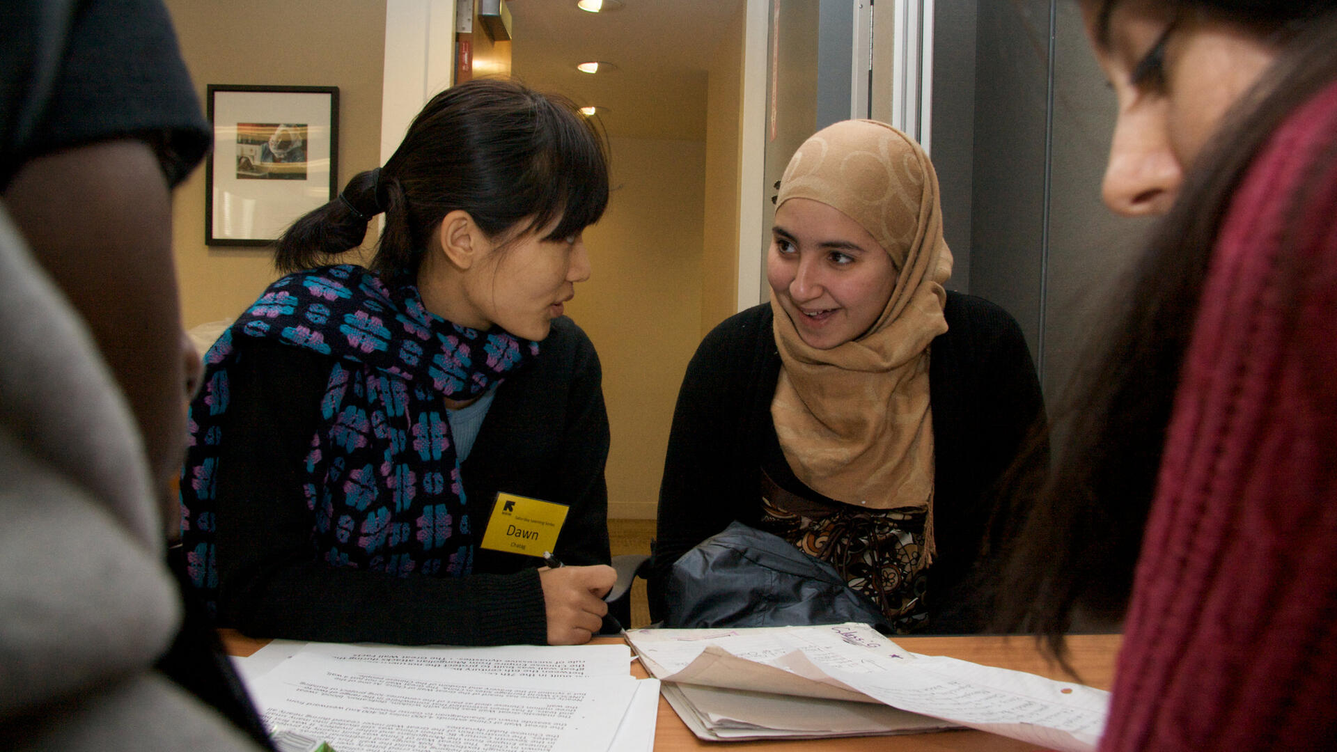 Volunteers work with refugees in an ESL class at the IRC resettlement office in New York