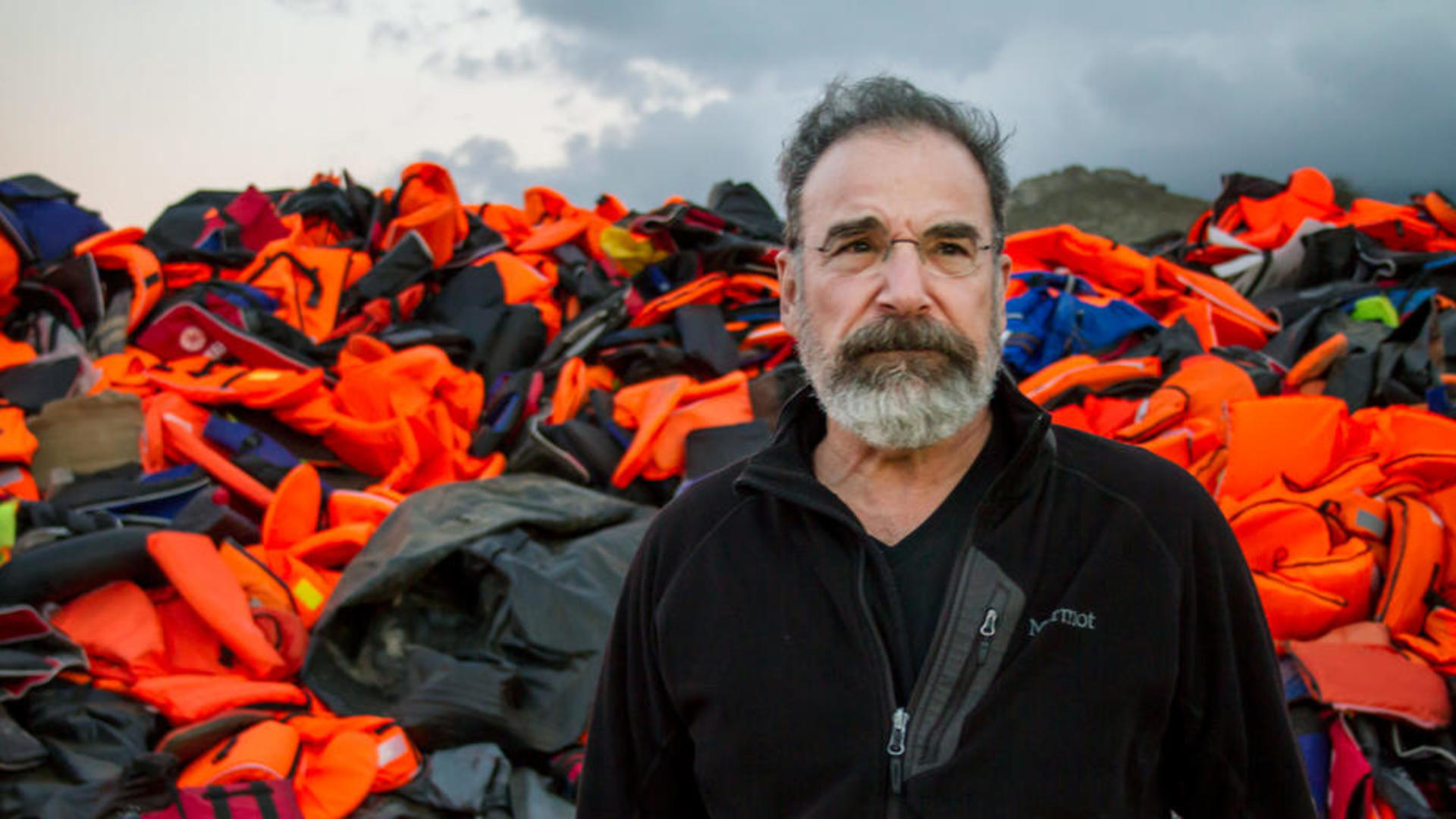 Mandy Patinkin in Greece, with a mountain of refugees' lifejackets