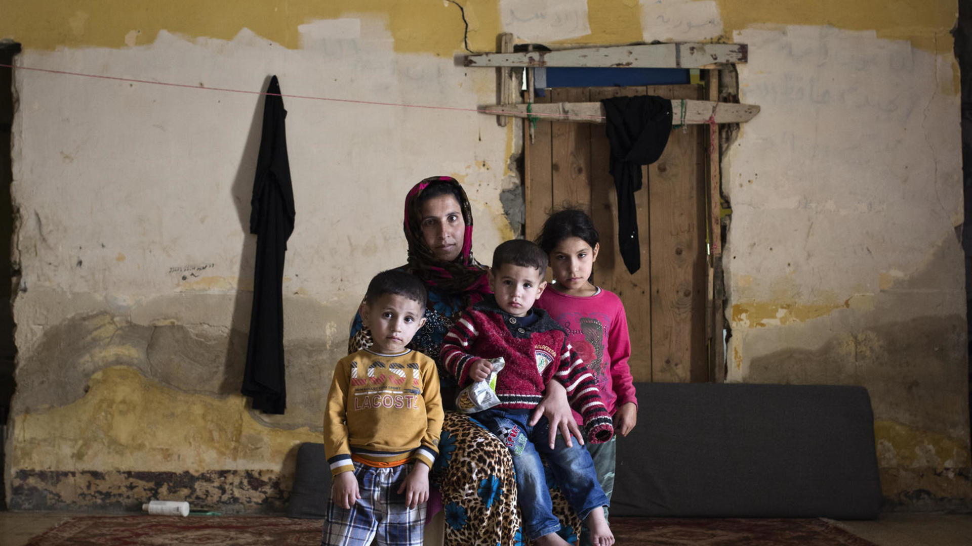 A Syrian family living as refugees in an abandoned building in Lebanon. A Syrian family living as refugees in an abandoned building in Lebanon.