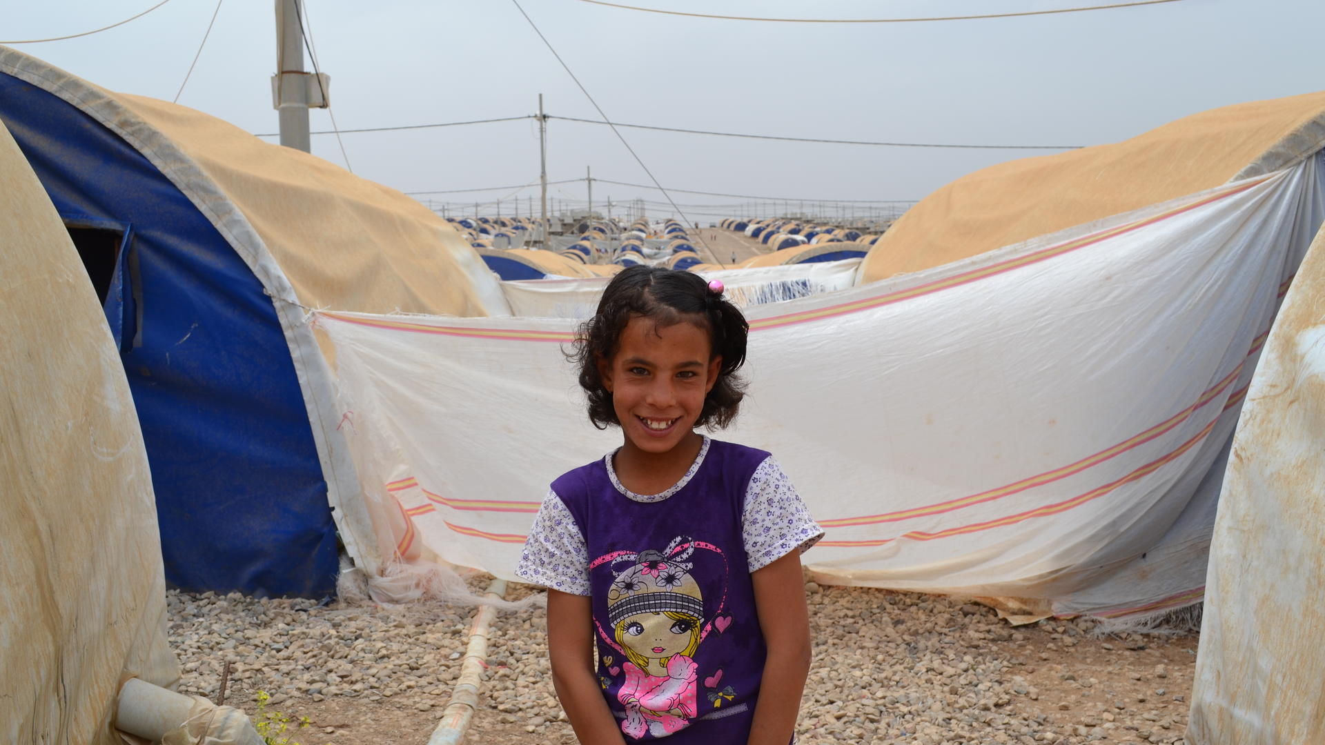 11-year-old Farah outside her family's tent in Nargazilia camp