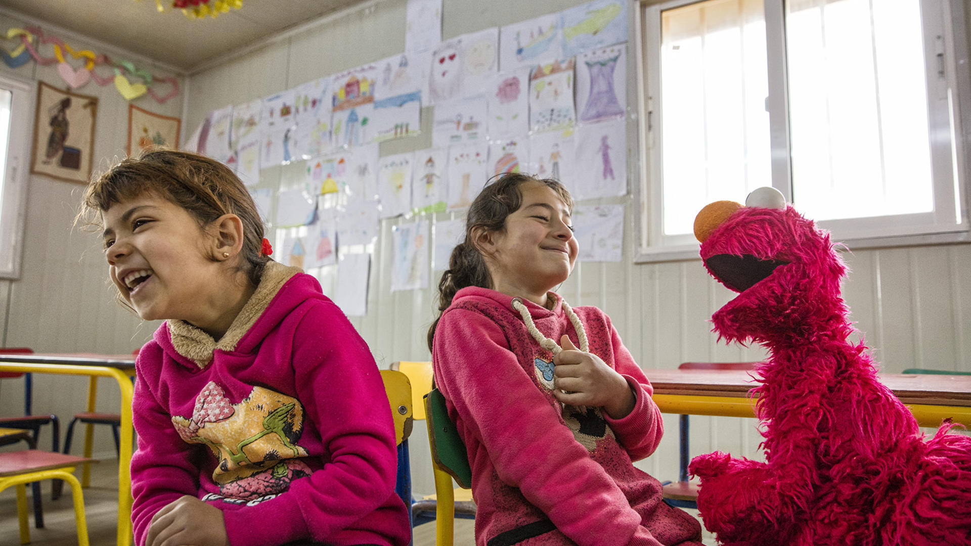Elmo, the Sesame Street Muppet, visits Syrian refugee children Elmo, the Sesame Street Muppet, makes two Syrian refugee girls laugh