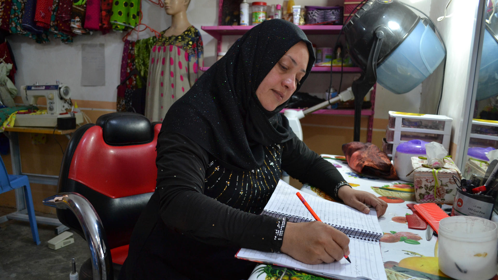 Entrepreneur Alia works at her desk at one of her business