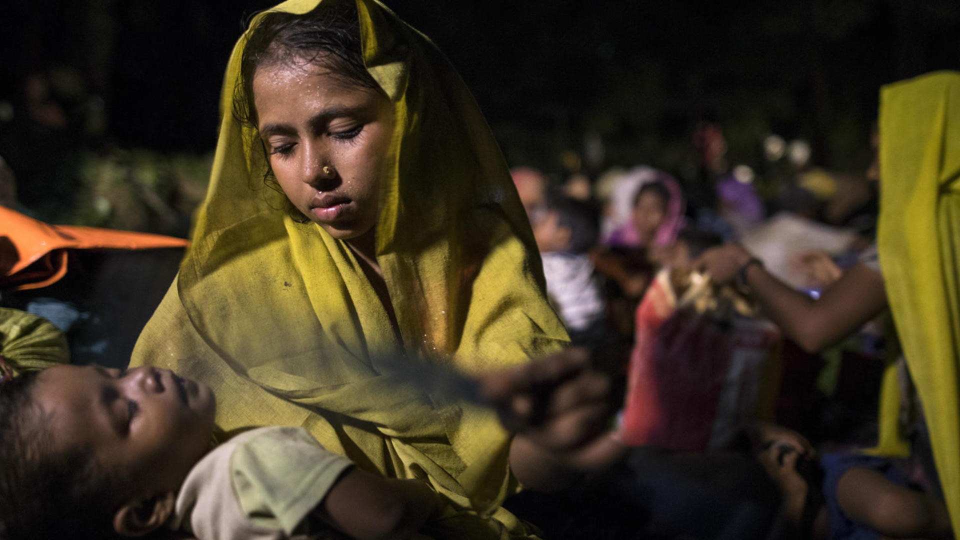 A Rohingya woman iholds her sleeping child