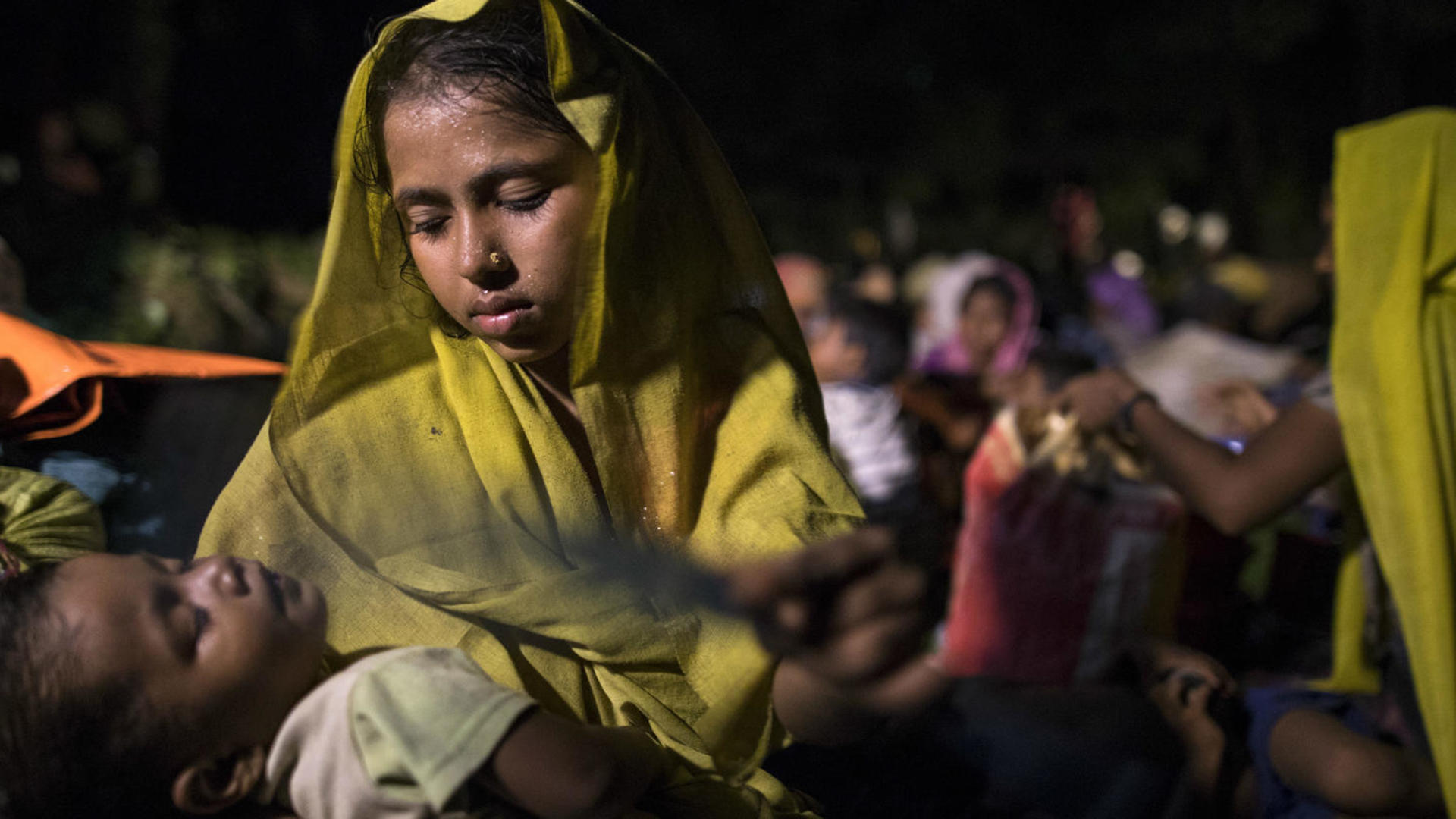 A Rohingya Muslim woman in Bangladesh holds her sleeping child A Rohingya woman iholds her sleeping child