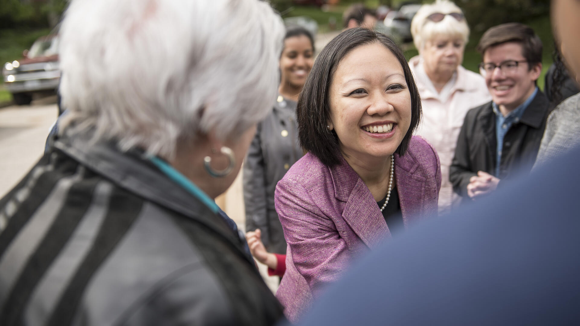 Kathy Tran shakes hands with voters while campaigning for a seat in the Virginia State House