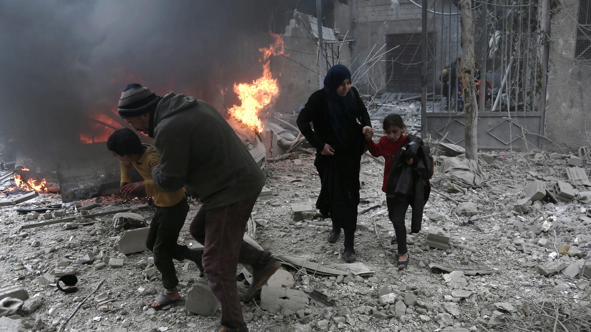 Syrian civilians run for cover from bombardment in Eastern Ghouta, Syria. Photo: Abdulmonam Eassa/AFP Syrian civilians run for cover from bombardment in Eastern Ghouta, Syria. Photo: Abdulmonam Eassa/AFP