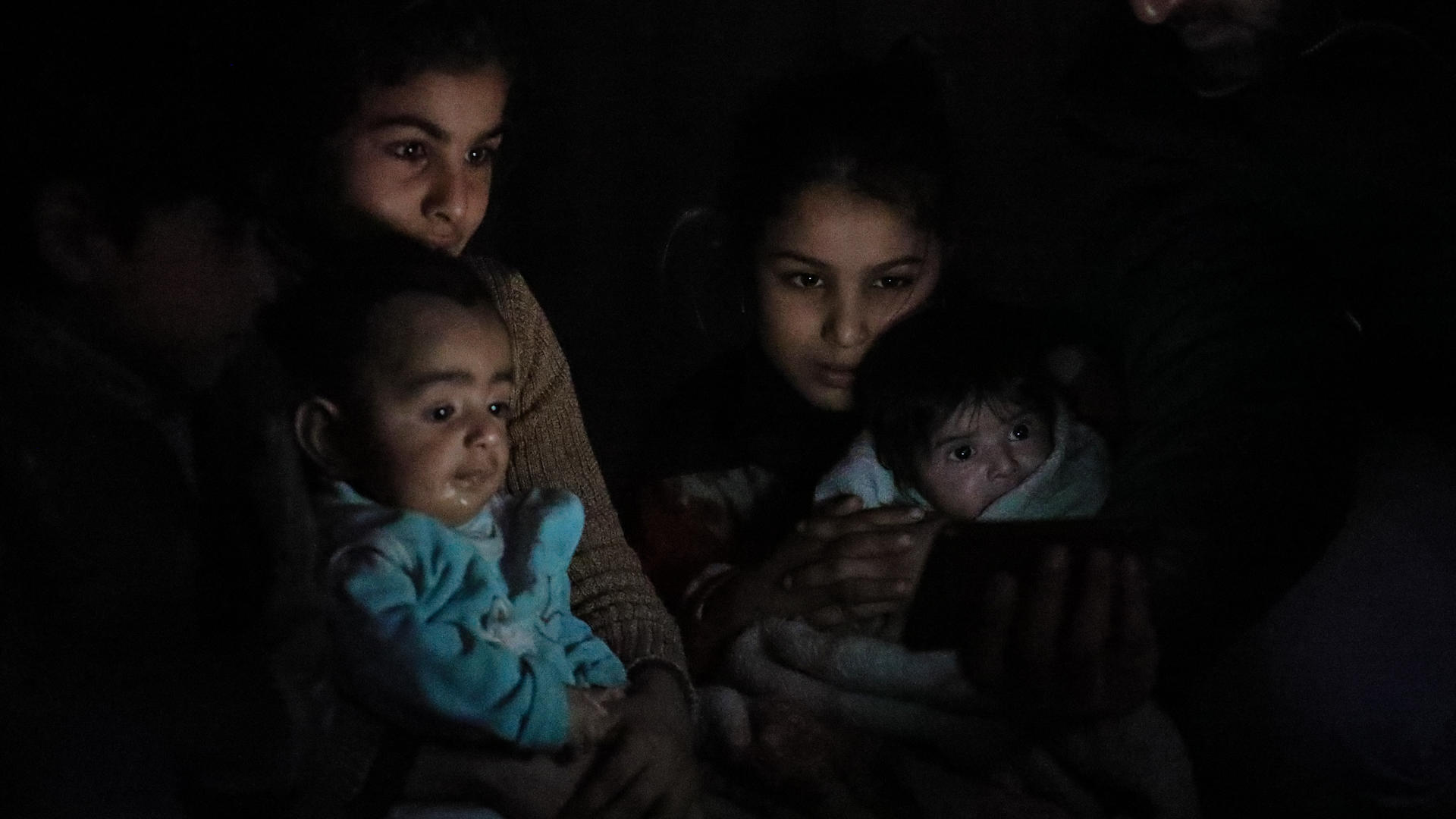 Young girls soothe babies sheltering underground in Eastern Ghouta. 