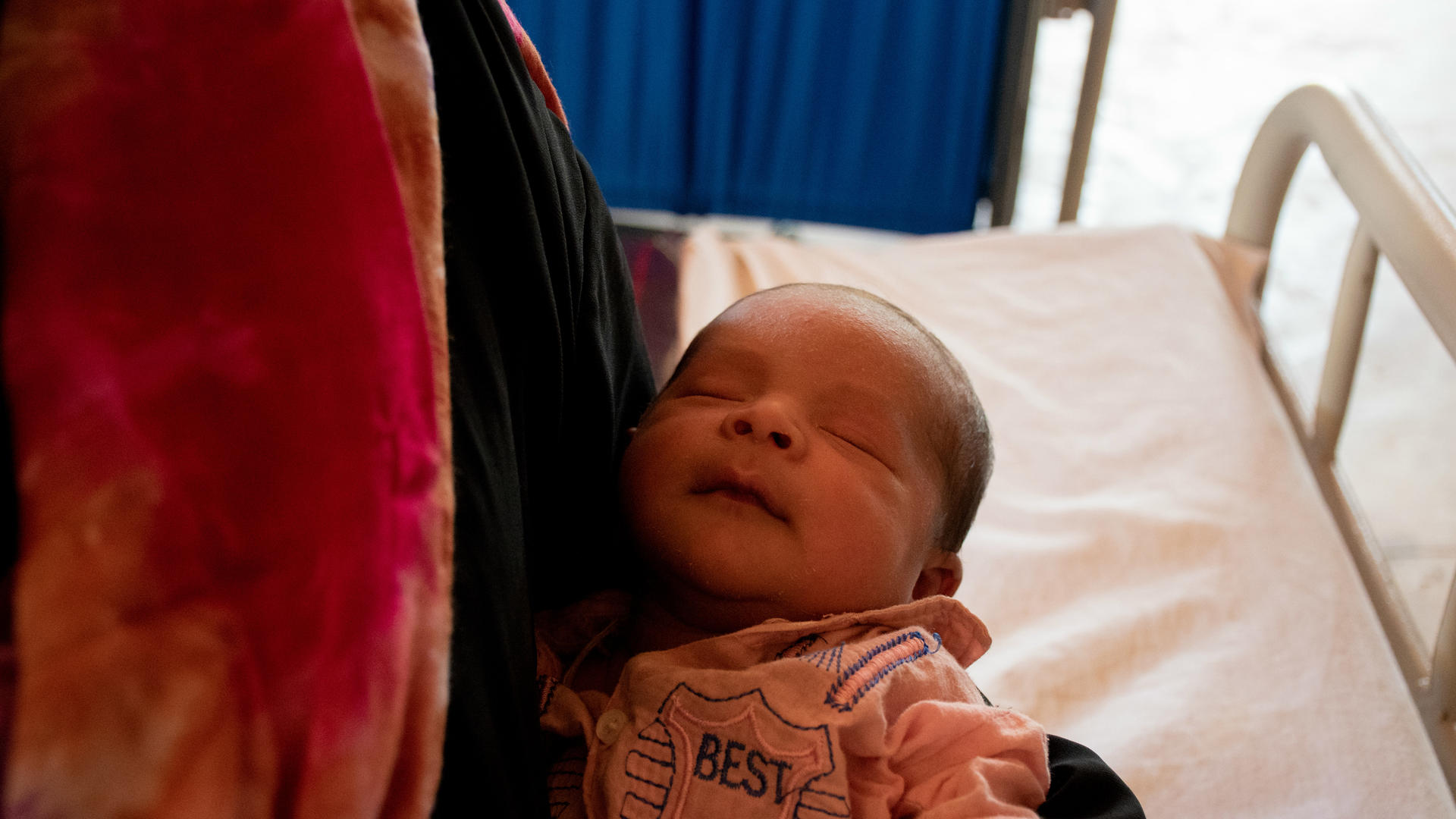 A four-day-old Rohingya boy, born in Kutupalong refugee camp in Bangladesh A newborn Rohingya boy in his mother's arms