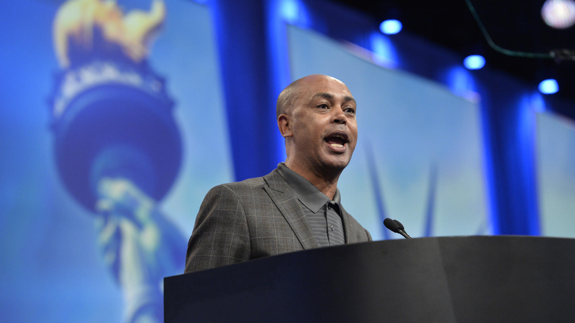 Tefere Gebre speaks at a podium at an AFL-CIO event