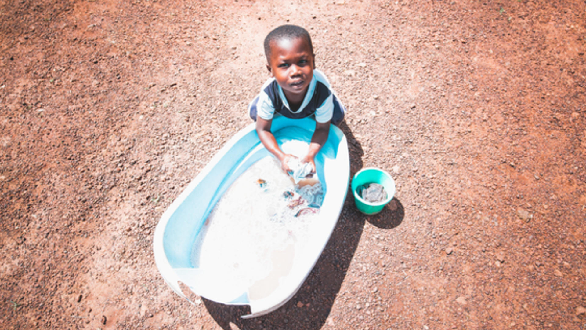 Young boy washes hands