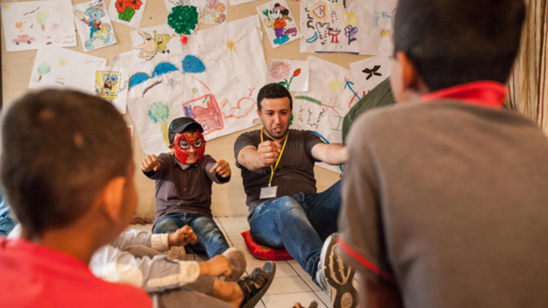 Syrian refugee boys in Beirut play at IRC play space