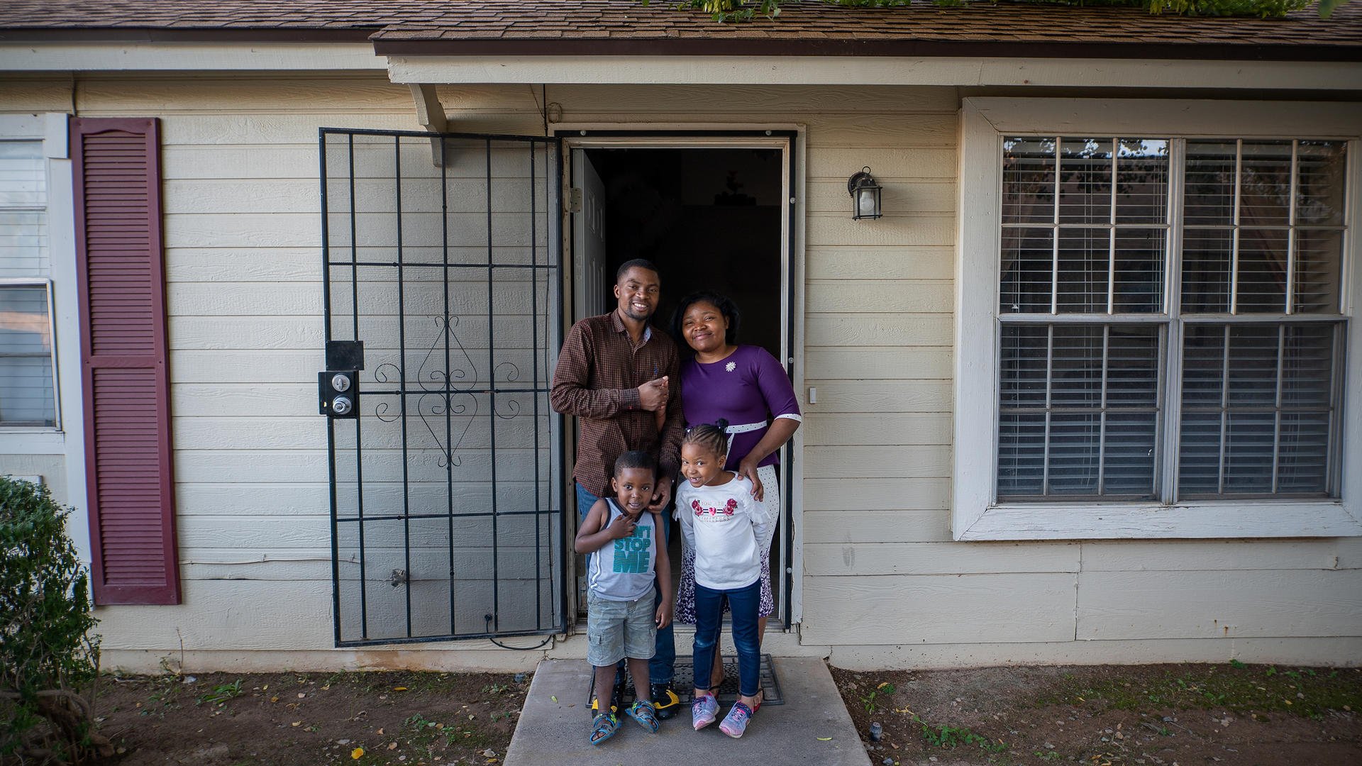 Congolese refugee family outside home in Arizona